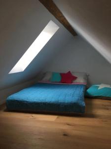 a bedroom with a blue bed in a attic at Loft Apartment in Central Zug in Zug