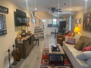 a living room with a couch and a table at StockYards-BBobs-4mins! GrayLee House.4-Bedrooms in Fort Worth