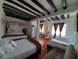 Ліжко або ліжка в номері VILLA LUISA HOTELs VILLA DE LEYVA