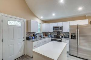 a kitchen with white cabinets and a refrigerator at StockYards-BBobs-4mins! GrayLee House.4-Bedrooms in Fort Worth