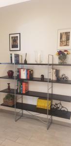 a shelf with books on it in a room at Laghirla in Modena