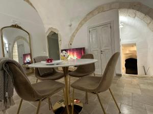 a table and chairs in a room with a fireplace at Arquati Suite Luxury Apartment in Ostuni +20 photos