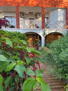 a building with a walkway in the middle of plants at Teanehi Bed & Breakfast in Hanga Roa