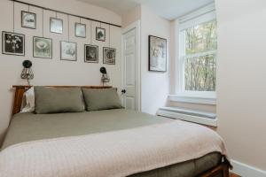 a bedroom with a large bed and a window at Rivers Ledge - 62 Acre Nature Retreat in Eldred