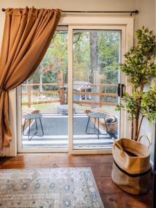 an open door to a deck with a patio at Rivers Ledge - 62 Acre Nature Retreat in Eldred