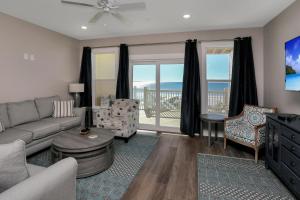 a living room with a couch and a table at Pelican's Perch by Pristine Properties Vacation Rentals in Saint Joe Beach