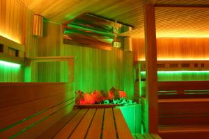 a sauna with green lights in a room at Holiday Beach Budapest Wellness Hotel with Sauna Park in Budapest