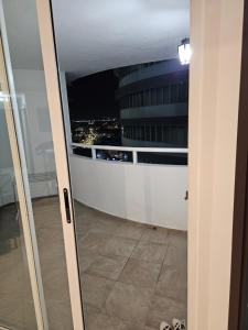 an open door to a balcony with a view of a building at Apartamento Bay View Panama cinta costera in Panama City