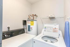 a laundry room with a washing machine and a washer at Pelican Landing 2 in Indian Pass