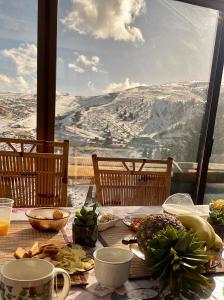 a table with food and a view of a mountain at Chalet Hilltop Kodra e Diellit Popovo Sapka in Tetovo