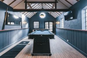 a pool table in a room with blue walls at House with a cinema and games room, sleeps 17 in Shrewsbury