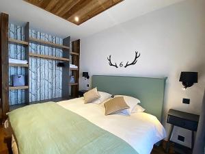 a bedroom with a large bed and a window at Chalet Les Gets, 5 pièces, 14 personnes - FR-1-598-19 in Les Gets