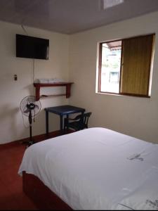 En eller flere senger på et rom på Hotel El Cristal