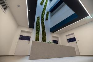 a lobby with a plant in a wall at Mistral Residence 308 in Balatonföldvár