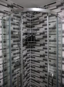 a shower with a glass enclosure in a bathroom at K&i Lakeside Retreat in Southport