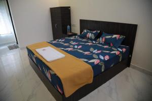 a bedroom with a bed with a laptop on it at Heaven Resorts in Yercaud