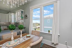 a dining room with a table and a window at Havin A Blas by Pristine Properties Vacation Rentals in Cape San Blas
