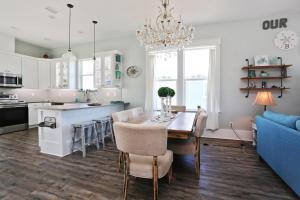 a kitchen and dining room with a table and a blue couch at Havin A Blas by Pristine Properties Vacation Rentals in Cape San Blas