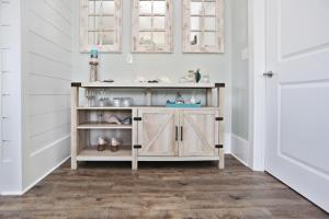 a wooden cabinet in a room with white walls at Havin A Blas by Pristine Properties Vacation Rentals in Cape San Blas