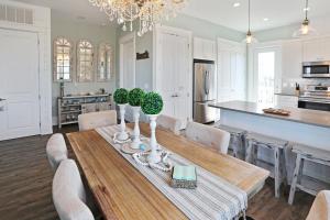 a kitchen and dining room with a table and chairs at Havin A Blas by Pristine Properties Vacation Rentals in Cape San Blas