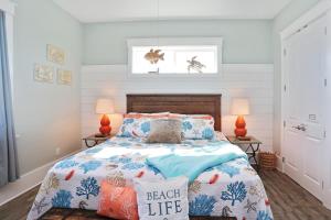 a bedroom with a bed with blue and orange pillows at Havin A Blas by Pristine Properties Vacation Rentals in Cape San Blas