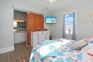 a bedroom with a bed and a dresser and a mirror at Havin A Blas by Pristine Properties Vacation Rentals in Cape San Blas
