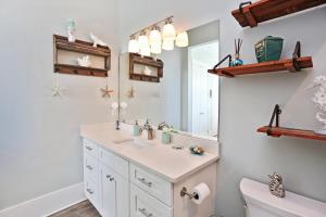a bathroom with a sink and a mirror at Havin A Blas by Pristine Properties Vacation Rentals in Cape San Blas