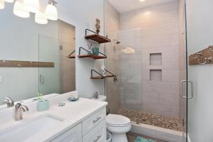 a bathroom with a shower and a toilet and a sink at Havin A Blas by Pristine Properties Vacation Rentals in Cape San Blas