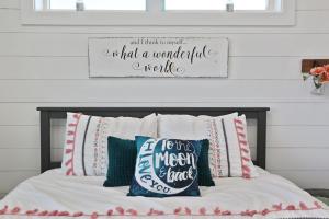 a bed with pillows and a sign on a wall at Havin A Blas by Pristine Properties Vacation Rentals in Cape San Blas
