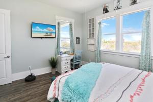 a bedroom with a bed and two windows at Havin A Blas by Pristine Properties Vacation Rentals in Cape San Blas