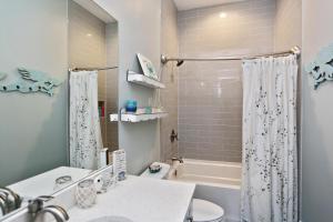 a bathroom with a sink and a toilet and a tub at Havin A Blas by Pristine Properties Vacation Rentals in Cape San Blas