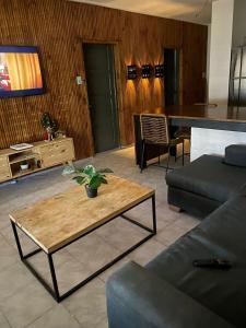 a living room with a couch and a table at Alquiler por dia in San Carlos de Bolívar