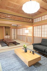 a living room with a couch and a table at Utage HANARE - Vacation STAY 93680v in Kainan