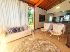 - un salon avec un canapé, des chaises et une table dans l'établissement Pousada Villa Magna - Casa 4, à Diamantina