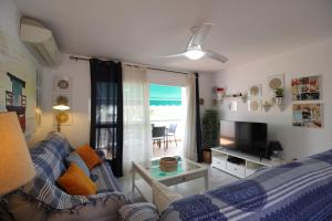 a living room with a couch and a television at Lunamar El mejor Resort en la mejor Playa in Marbella