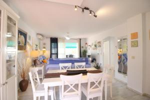 a dining room and living room with a table and chairs at Lunamar El mejor Resort en la mejor Playa in Marbella