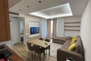 a living room with a couch and a table at Entire holiday flat in Sarande in Sarandë