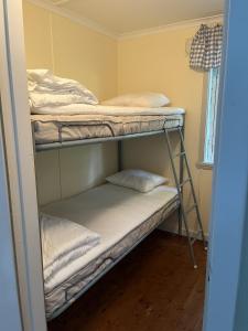 a bunk room with two bunk beds in it at Ormanäs Stugby in Höör