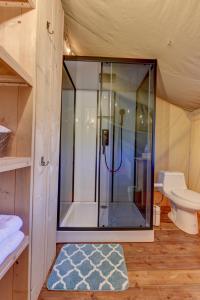 a bathroom with a shower and a toilet at Tent#1-Luxury Camping Tent in Hill Country, Texas in Johnson City