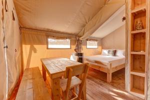 a room with a bed and a table in a tent at Tent#1-Luxury Camping Tent in Hill Country, Texas in Johnson City