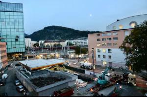 an overhead view of a city with buildings and vehicles at Evido Apartments in Salzburg