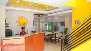 a man sitting at a counter in a restaurant at StayLite in Tagbilaran City