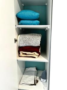 a closet filled with towels and pillows at Tranquil Living on Maboneng in Johannesburg