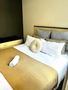 a bed with a white pillow on top of it at Tranquil Living on Maboneng in Johannesburg