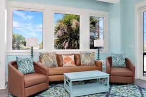 a living room with a couch and two chairs at Beach View Upper by Pristine Properties Vacation Rentals in Mexico Beach