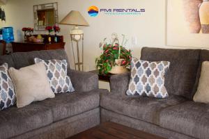 two couches sitting in a living room with pillows at Marina Pinacate C-518 in Puerto Peñasco