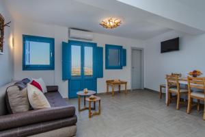 a living room with a couch and a table at ADAMANTIOS VILLAS & SUITES in Akrotiri