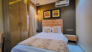 a small bedroom with a bed and a closet at Abados Leisure Hotel and Lounge in Lagos