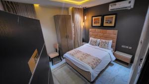 a small bedroom with a bed in a room at Abados Leisure Hotel and Lounge in Lagos