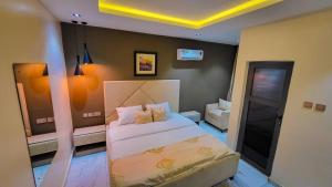 a small bedroom with a bed and a couch at Abados Leisure Hotel and Lounge in Lagos